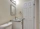 Bathroom features a white vanity with granite countertop and framed mirror at 2835 Bongart Rd, Winter Park, FL 32792