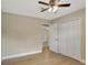 Bedroom with hardwood floors, closet, ceiling fan, and a doorway at 2835 Bongart Rd, Winter Park, FL 32792
