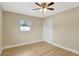 Bedroom with ceiling fan, light hardwood floors, window, and closet at 2835 Bongart Rd, Winter Park, FL 32792