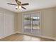 Bedroom featuring wood-look floors, closet, ceiling fan, and a sliding glass door to the backyard at 2835 Bongart Rd, Winter Park, FL 32792