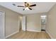 Bedroom with hardwood floors and ceiling fan with view of bathroom at 2835 Bongart Rd, Winter Park, FL 32792