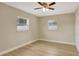 Bedroom with hardwood floors, two windows, and a closet at 2835 Bongart Rd, Winter Park, FL 32792