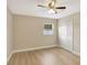 Bedroom with ceiling fan, light hardwood floors, window, and closet at 2835 Bongart Rd, Winter Park, FL 32792