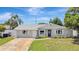 Inviting single-story home with white trim, lovely landscaping, and a sunny front yard at 2835 Bongart Rd, Winter Park, FL 32792