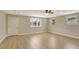 Bright living room featuring wood-look floors, recessed lighting, ceiling fan, and a large window at 2835 Bongart Rd, Winter Park, FL 32792