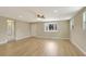 Open living room showcasing beautiful wood-look floors and natural light from multiple windows at 2835 Bongart Rd, Winter Park, FL 32792