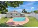 Landscaped backyard features a sparkling pool, complemented by a well-maintained yard and a charming home exterior at 2835 Bongart Rd, Winter Park, FL 32792