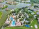 Aerial view of neighborhood with large pool, tennis courts, playground, and lake access at 2901 Agostino Ter, Kissimmee, FL 34746
