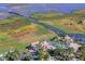 Aerial view of Bellalago's clubhouse and pool area with a scenic pier extending into the water at 2901 Agostino Ter, Kissimmee, FL 34746