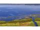 Expansive lake view featuring a wooden walkway leading to a gazebo, offering a tranquil escape surrounded by nature at 2901 Agostino Ter, Kissimmee, FL 34746