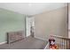 A carpeted bedroom features a crib, dresser, green accent wall, and ample closet space at 2901 Agostino Ter, Kissimmee, FL 34746