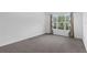 Bright bedroom featuring a large window with natural light and neutral carpet at 2901 Agostino Ter, Kissimmee, FL 34746