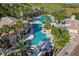 Aerial view of Bellalago's community pool features a waterslide, lounge chairs, and lush tropical landscaping at 2901 Agostino Ter, Kissimmee, FL 34746