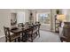Elegant dining room with a large window, modern decor, and comfortable seating arrangement at 2901 Agostino Ter, Kissimmee, FL 34746
