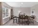 Bright dining room with large window, shelving, and modern table set for six guests at 2901 Agostino Ter, Kissimmee, FL 34746