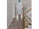 Spacious foyer with tile flooring, a staircase with wooden banister, and soaring ceilings at 2901 Agostino Ter, Kissimmee, FL 34746