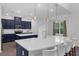 Spacious kitchen with large island, white countertops, and blue cabinetry featuring pendant lighting at 2901 Agostino Ter, Kissimmee, FL 34746