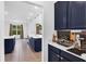 Stylish kitchen with blue cabinetry, white countertops, stainless steel appliances, and an open layout at 2901 Agostino Ter, Kissimmee, FL 34746