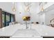 Large kitchen island featuring white countertops and views of living room with modern lighting at 2901 Agostino Ter, Kissimmee, FL 34746