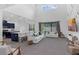 Spacious living room features a large window, comfortable white couches, and open to kitchen at 2901 Agostino Ter, Kissimmee, FL 34746