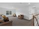 Bright living room with neutral carpet and comfortable seating near staircase at 2901 Agostino Ter, Kissimmee, FL 34746