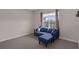 Comfortable sitting area with blue sofa, carpet and natural light at 2901 Agostino Ter, Kissimmee, FL 34746