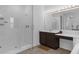 The main bathroom features a shower, a vanity with make up area and dark cabinets at 2901 Agostino Ter, Kissimmee, FL 34746