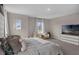 Carpeted main bedroom featuring sitting area, large TV, and king bed with a decorative headboard at 2901 Agostino Ter, Kissimmee, FL 34746