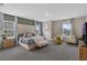 A spacious main bedroom features carpet floors, a king bed, seating and natural light at 2901 Agostino Ter, Kissimmee, FL 34746