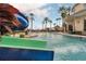 Fun outdoor pool area with a waterslide, palm trees, and a clubhouse perfect for relaxation and recreation at 2901 Agostino Ter, Kissimmee, FL 34746