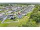 An aerial view depicts a house with a fenced backyard and lush greenery amidst a suburban setting at 2914 Scarlett Dr, St Cloud, FL 34772
