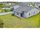Backyard view of a house with a well-kept lawn and an enclosing white fence at 2914 Scarlett Dr, St Cloud, FL 34772
