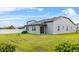 Spacious backyard featuring a lush lawn, white fence and covered patio area perfect for outdoor activities at 2914 Scarlett Dr, St Cloud, FL 34772