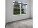 Bedroom showcasing gray carpet flooring, large windows, and a serene atmosphere at 2914 Scarlett Dr, St Cloud, FL 34772