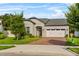 Inviting single-Gathering home with a brick driveway, a two-car garage, and neatly trimmed shrubs at 2914 Scarlett Dr, St Cloud, FL 34772