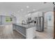 Open kitchen with stainless steel appliances and island with sink at 2914 Scarlett Dr, St Cloud, FL 34772