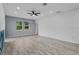 A spacious room featuring hardwood floors, two windows, and recessed lighting at 2914 Scarlett Dr, St Cloud, FL 34772