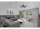 Staged living room with couch, chair, and area rug at 2914 Scarlett Dr, St Cloud, FL 34772