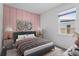 A stylishly decorated bedroom featuring pastel pink wall decor and modern accents at 2914 Scarlett Dr, St Cloud, FL 34772