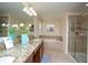 Bathroom with granite countertops, a walk-in shower, and a large soaking tub at 2928 Buccaneer Palm Rd, Kissimmee, FL 34747