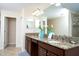 Bathroom with granite countertops, double sinks, and natural light at 2928 Buccaneer Palm Rd, Kissimmee, FL 34747