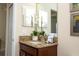 Close up of a bathroom featuring a granite countertop and dark wood cabinets at 2928 Buccaneer Palm Rd, Kissimmee, FL 34747