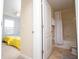 Shared bathroom with tub, shower and access to bedroom with bright yellow comforter at 2928 Buccaneer Palm Rd, Kissimmee, FL 34747
