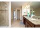 Bathroom with granite countertops, shower, and double-sink vanity at 2928 Buccaneer Palm Rd, Kissimmee, FL 34747