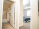 Bathroom with a shower-tub combination and view to a bedroom with natural light at 2928 Buccaneer Palm Rd, Kissimmee, FL 34747