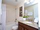 Well-lit bathroom featuring a shower-tub combo, granite vanity top and coordinated decor at 2928 Buccaneer Palm Rd, Kissimmee, FL 34747