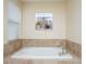 Elegant bathroom with large soaking tub and decorative tile surround at 2928 Buccaneer Palm Rd, Kissimmee, FL 34747
