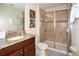 Stylish bathroom featuring a granite countertop vanity and a glass-enclosed shower at 2928 Buccaneer Palm Rd, Kissimmee, FL 34747