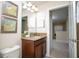 Bathroom vanity features granite countertop, framed mirror, modern fixtures and bright lighting at 2928 Buccaneer Palm Rd, Kissimmee, FL 34747