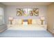 Bright and spacious bedroom with bed featuring decorative pillows and modern art at 2928 Buccaneer Palm Rd, Kissimmee, FL 34747